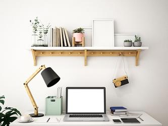 home working desk with laptop, notebook, lamp and shelf